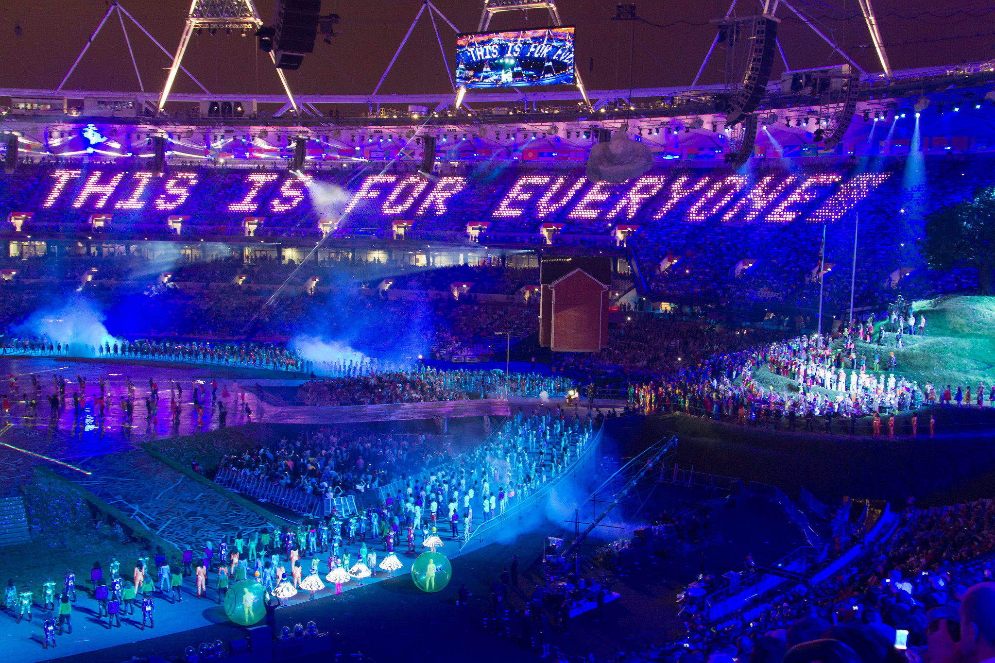 A photo taken at the section of the London 2012 Olympic opening ceremony where they celebrated the web and Tim Berners-Lee. I choked up at this point, when lights in the stadium seating formed the words 'this is for everyone' in large command-line-looking text including a blinking cursor at the end.